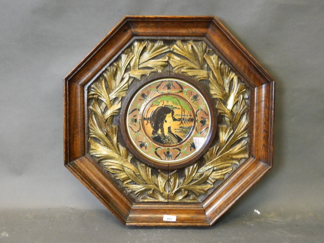 A late C19th/early C20th ceramic plaque with Art: A late C19th/early C20th ceramic plaque with Art Nouveau inspired border around a profile of a young woman, signed R. Dean verso, possibly Doulton, in a good frame with carved and parcel gilt border, 