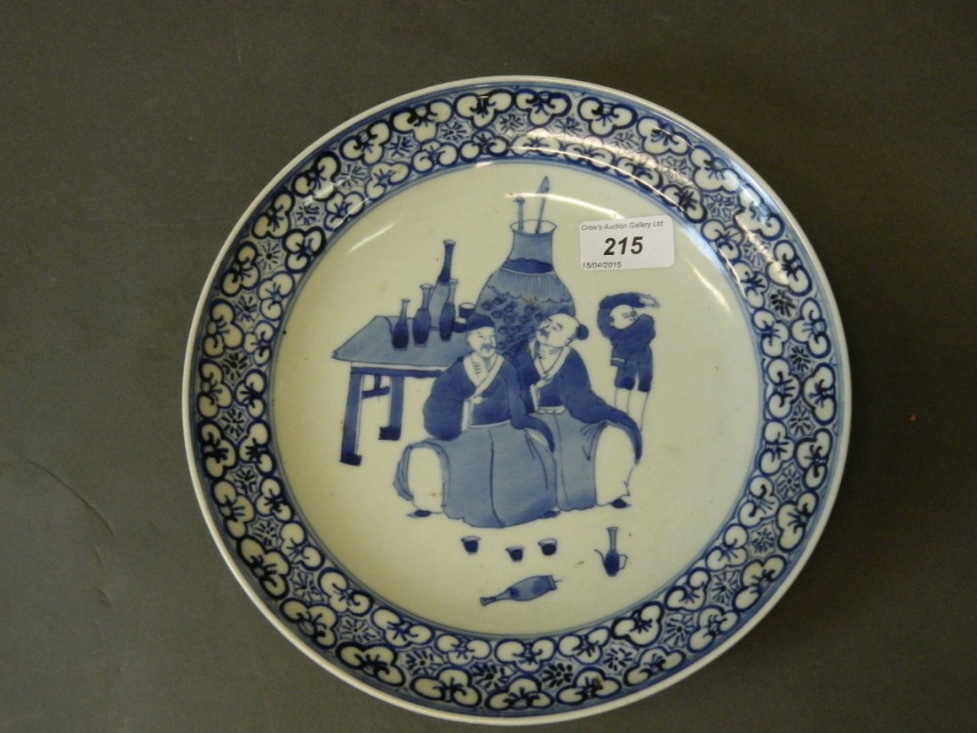 A Chinese porcelain dish with blue and white decoration: A Chinese porcelain dish with blue and white decoration of two gentlemen drinking wine with attendant boy, 10'' diameter
