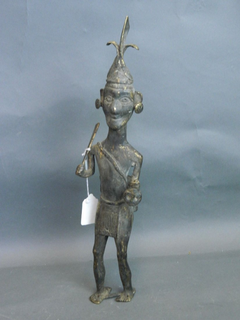 An Eastern bronze figure of a head hunter brandishing a: An Eastern bronze figure of a head hunter brandishing a machete, 16'' high
