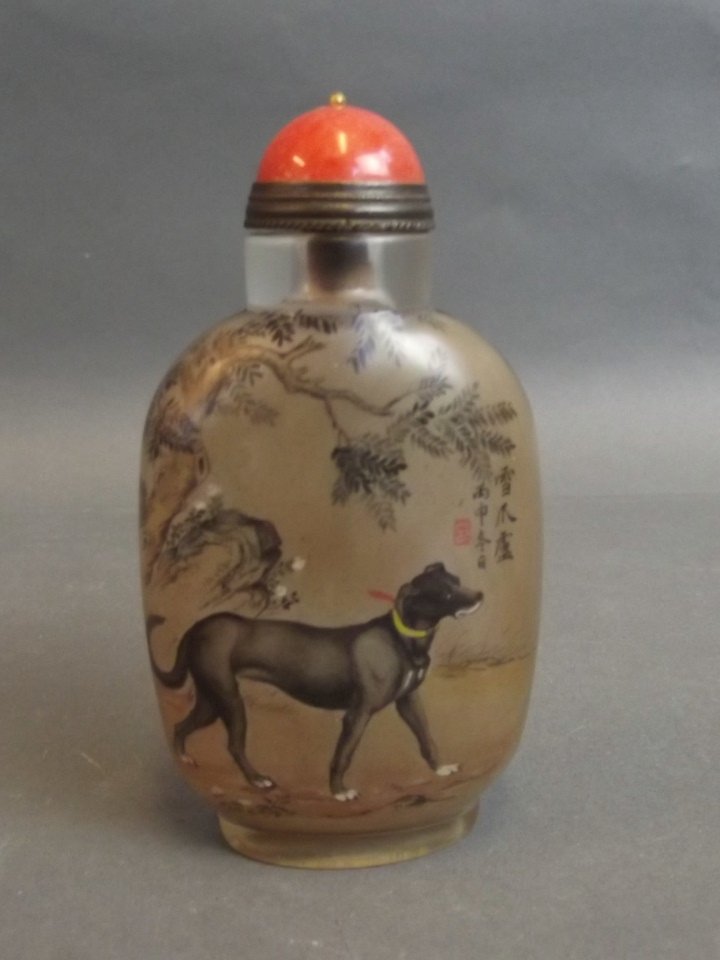 A Chinese glass snuff bottle with reverse painted: A Chinese glass snuff bottle with reverse painted decoration of dogs, 3¾'' high