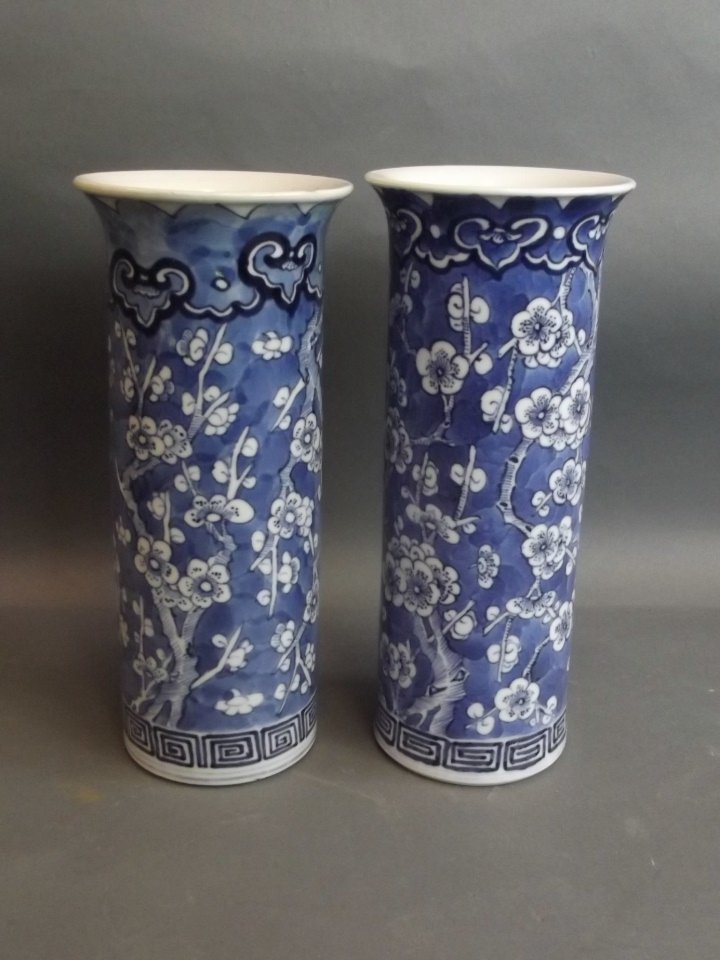 A pair of C19th Chinese blue and white porcelain: A pair of C19th Chinese blue and white porcelain cylindrical vases with cracked ice and prunus blossom decoration, 4 character mark, 8½'' high
