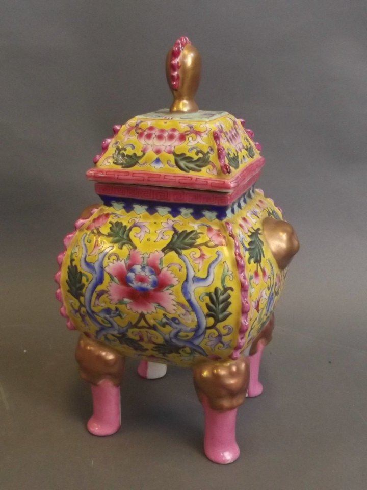 A Chinese yellow ground jar and cover decorated with: A Chinese yellow ground jar and cover decorated with flowers, supported by four lion mask legs, 10'' high, Best Bid
