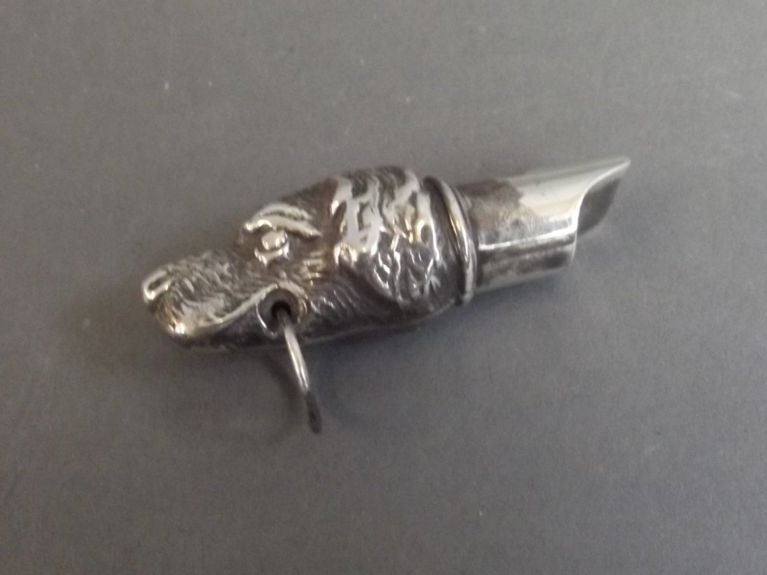 A silver 925 whistle in the form of a dog, 2'' long: A silver 925 whistle in the form of a dog, 2'' long
