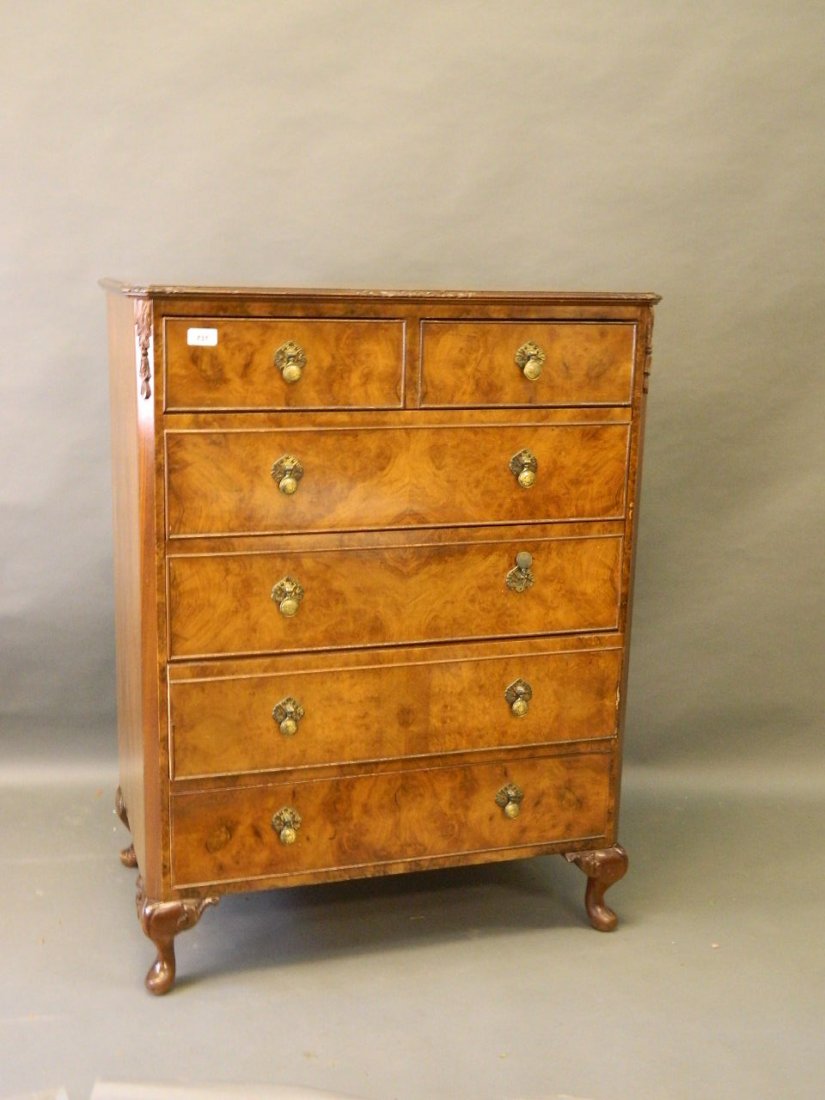 A 1930s burr walnut chest of two over four drawers with: A 1930s burr walnut chest of two over four drawers with carved decoration, on cabriole supports, en suite to previous lot, 31'' x 41'' x 19''