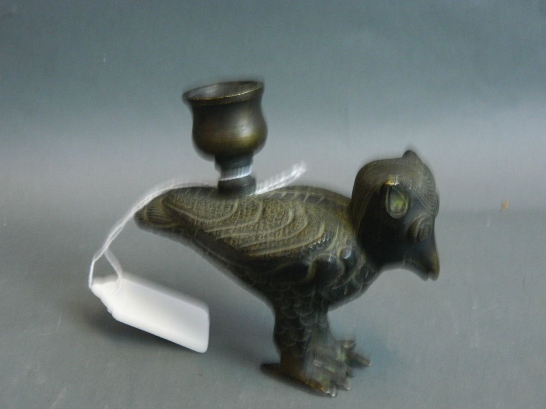 A bronze Indo-Persian candle holder in the form of a: A bronze Indo-Persian candle holder in the form of a bird, 4'' high