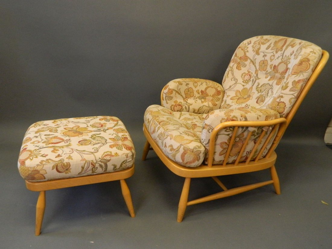 An Ercol beech wood armchair and matching stool, en: An Ercol beech wood armchair and matching stool, en suite to previous lot, 33'' wide