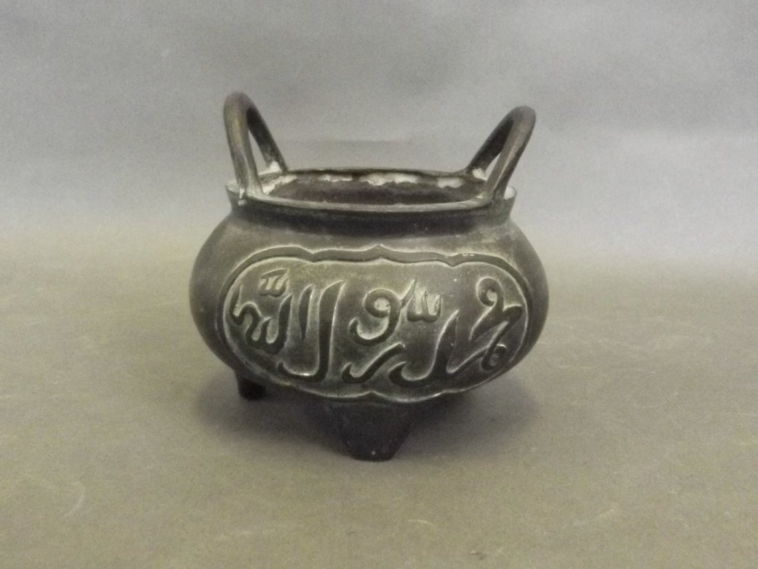 A Chinese twin handled bronze censer decorated with (1 of 2)