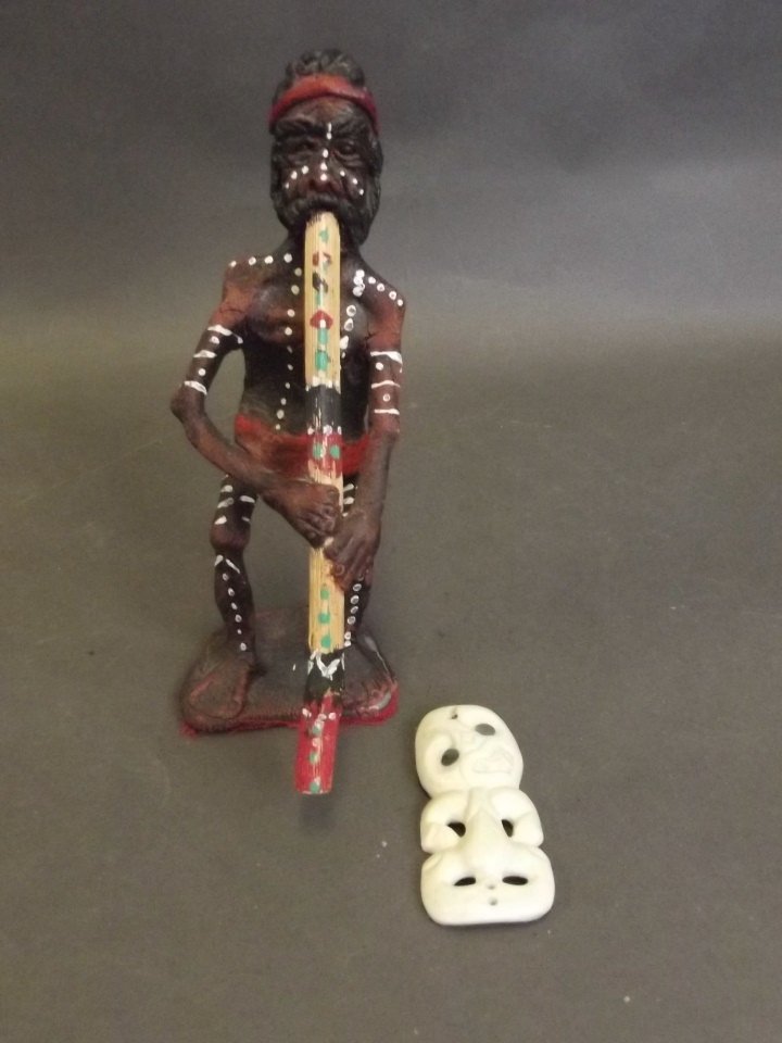 A Maori bone Tiki figure inset with Mother of Pearl,: A Maori bone Tiki figure inset with Mother of Pearl, and a composition Aboriginal figure, 3'' long