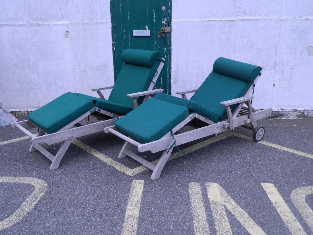 A pair of Indian Ocean Trading Co. teak garden: A pair of Indian Ocean Trading Co. teak garden recliners with pull out slides and cushions, 78'' x 29'' x 17''