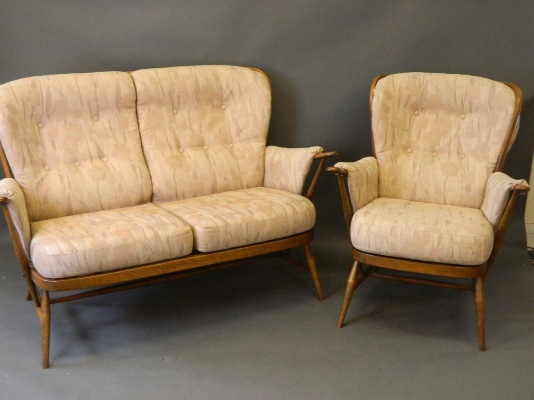 An Ercol stained beech two seater settee with matching: An Ercol stained beech two seater settee with matching chair, 36'' high