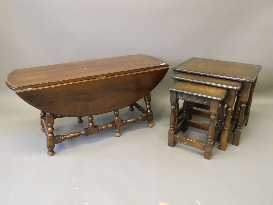 A nest of three Ercol dark oak occasional tables, and: A nest of three Ercol dark oak occasional tables, and an Ercol dark oak drop leaf circular occasional table, 42'' x 17''