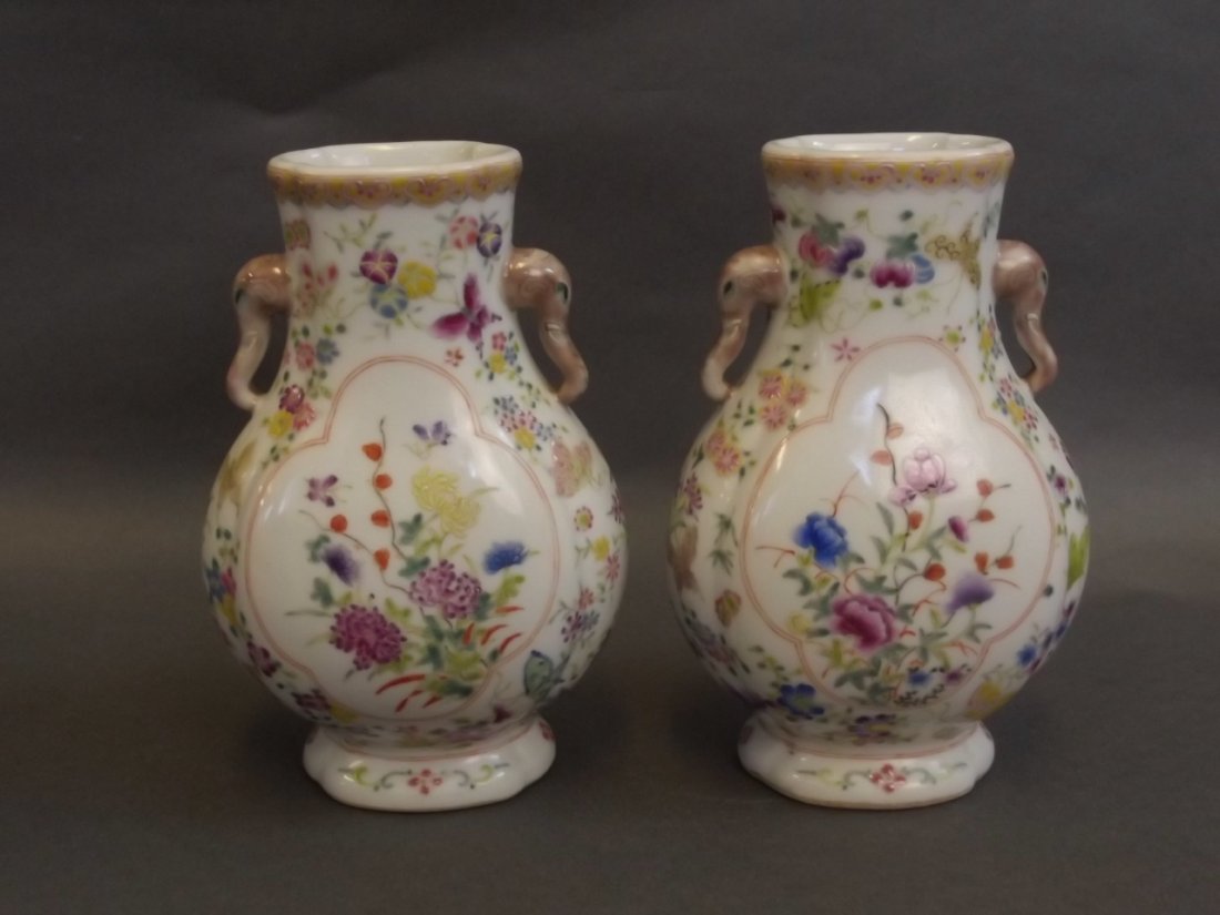 A pair of Chinese porcelain flasks with enamel: A pair of Chinese porcelain flasks with enamel decoration of insects amongst flowers, with twin elephant head handles, seal mark to base, 6½'' high