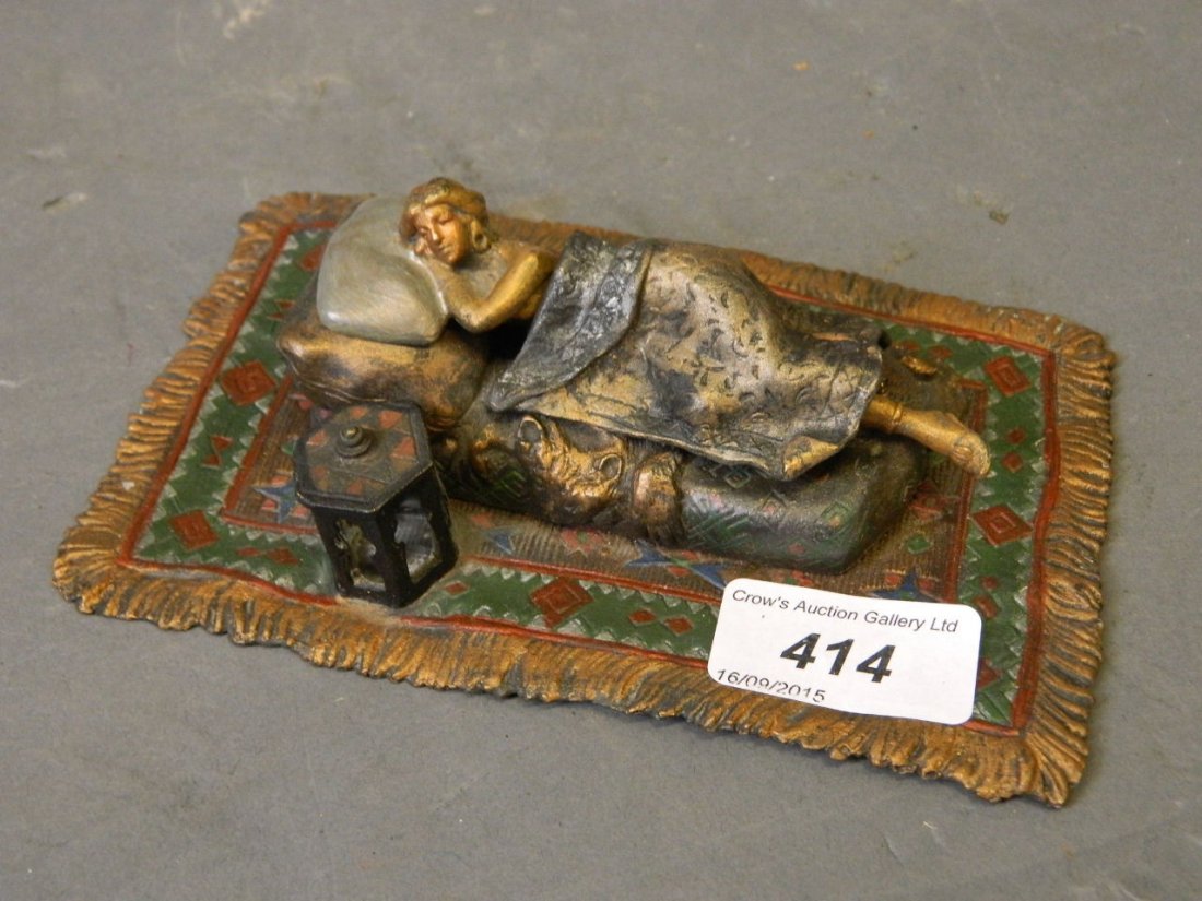 A cold painted bronze figure of a sleeping girl covered: A cold painted bronze figure of a sleeping girl covered in a removable blanket, after Bergman, 6'' long