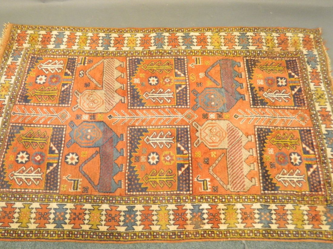 A Persian carpet with panel design depicting stylised (1 of 4)
