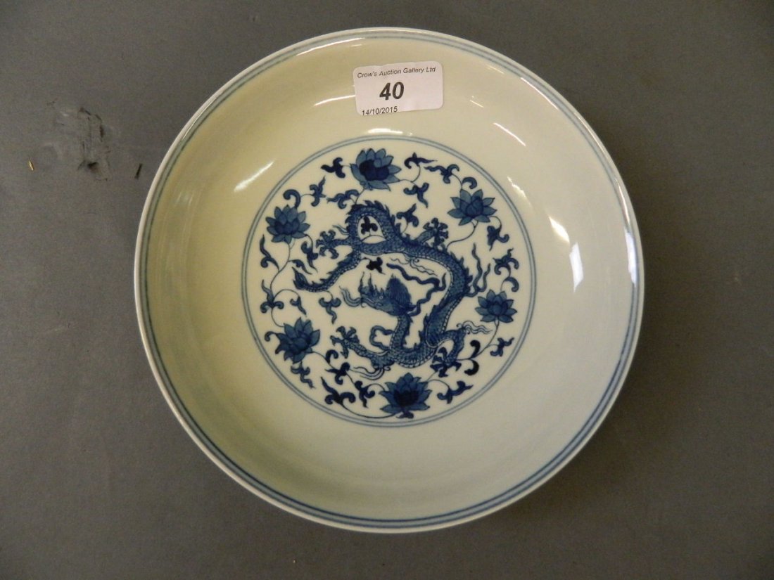 A Chinese blue and white dish decorated with a dragons,: A Chinese blue and white dish decorated with a dragons, 6 character mark to base, 7'' diameter