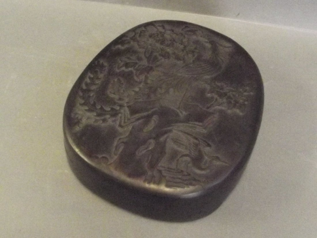 A large Chinese ink block carved with an exotic bird (1 of 2)
