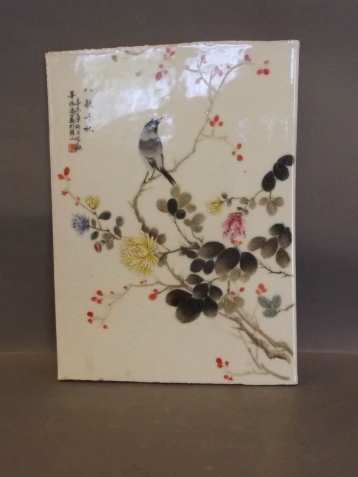 A Chinese ceramic plaque painted with a bird on a (1 of 2)