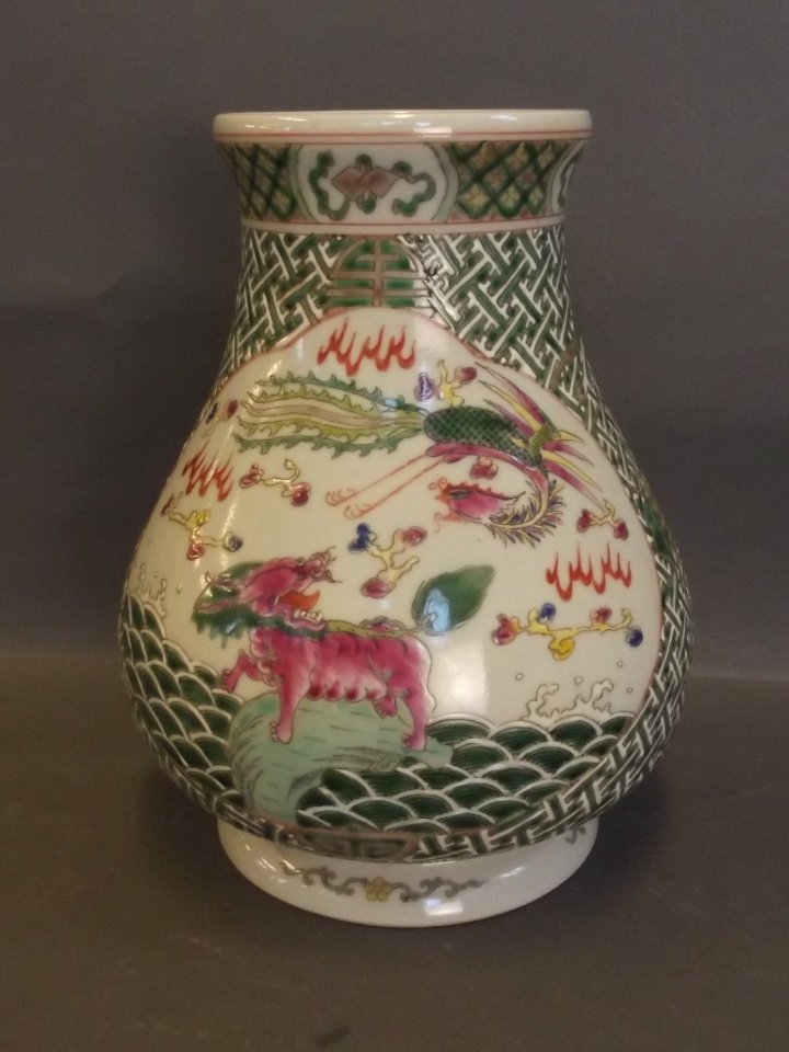 A Chinese green enamelled vase with a basket weave: A Chinese green enamelled vase with a basket weave decoration and painted dragon and carp, with lion dog and phoenix decoration verso, 6 character mark to base, 9'' high