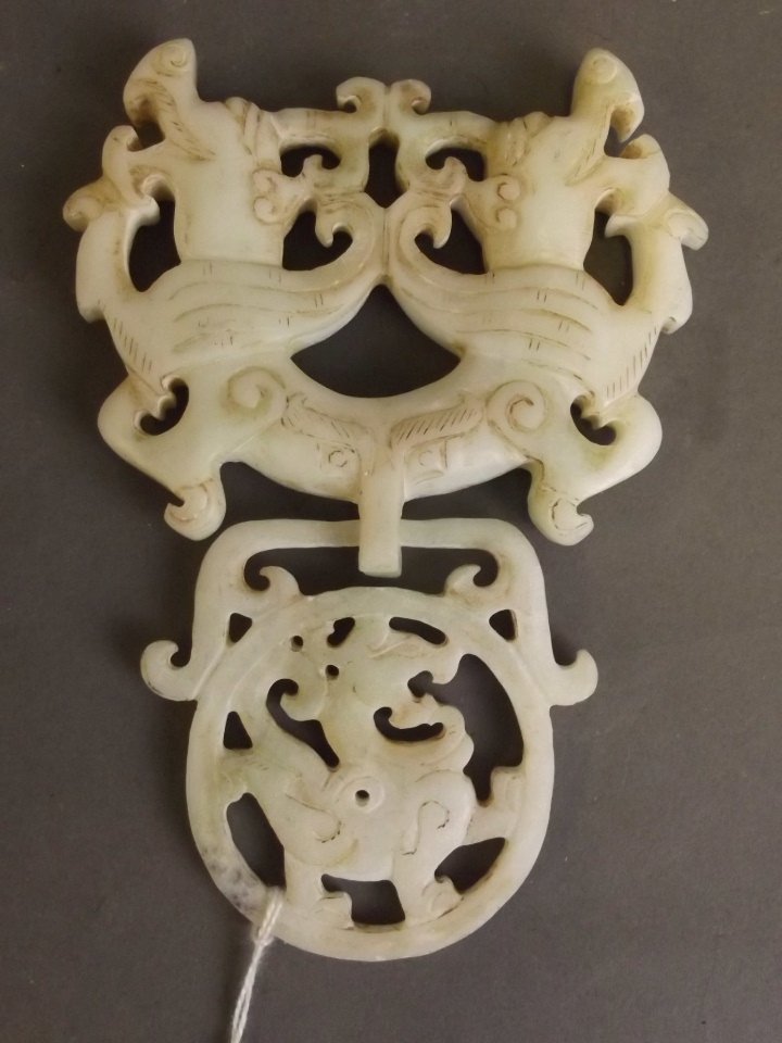 A Chinese white jade pendant in the form of two: A Chinese white jade pendant in the form of two entwined dragons, 5'' long