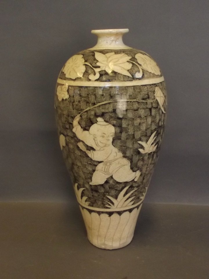 A Chinese Chizhou vase with decoration of children: A Chinese Chizhou vase with decoration of children flying a kite, 13'' high