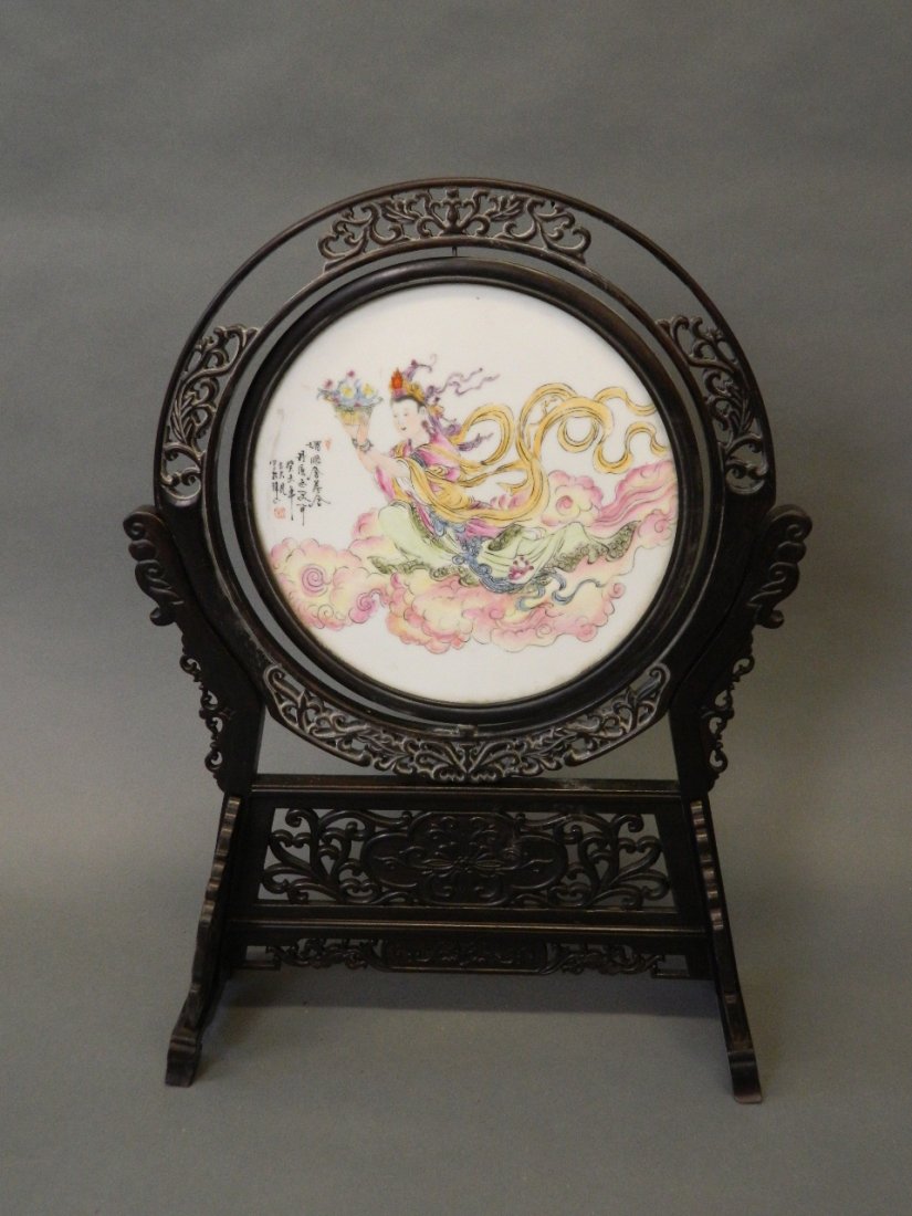 A Chinese ceramic plaque depicting a goddess sitting on (1 of 2)