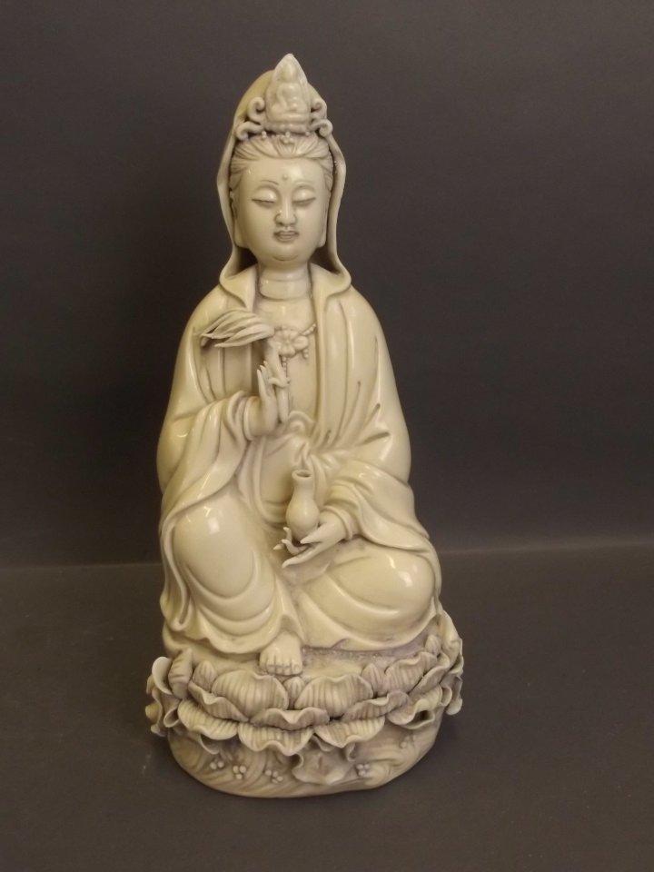 A Chinese blanc-de-chine figure of Quan Yin, impressed: A Chinese blanc-de-chine figure of Quan Yin, impressed mark verso, 10'' high