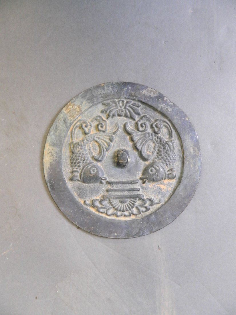 A Chinese patinated bronze mirror with relief carp (1 of 1)