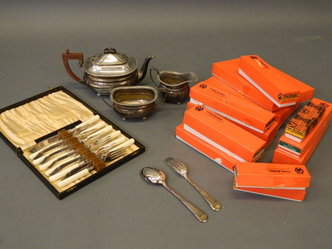 A quantity of silver plate to include a three piece tea: A quantity of silver plate to include a three piece tea set, a cased set of fish knives and forks, and a set of Cooper Bros rattail pattern flatware in boxes