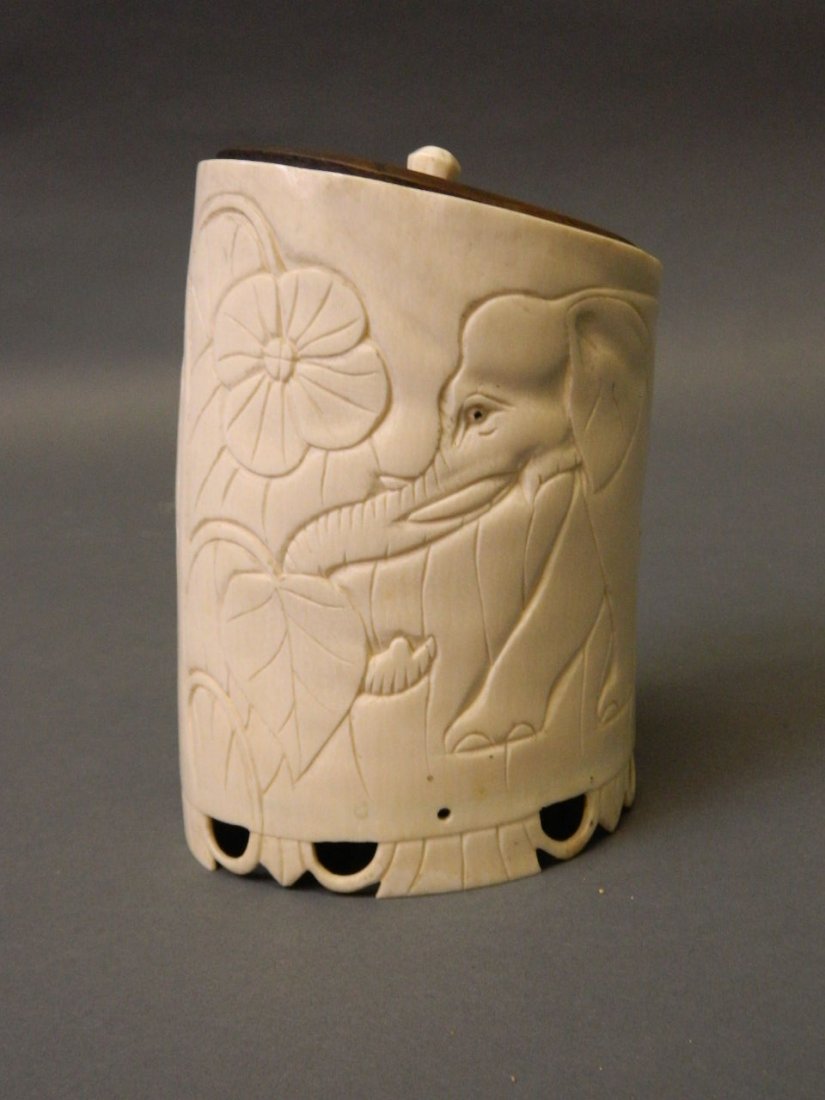 An early C20th carved ivory box with elephant and lion (1 of 2)