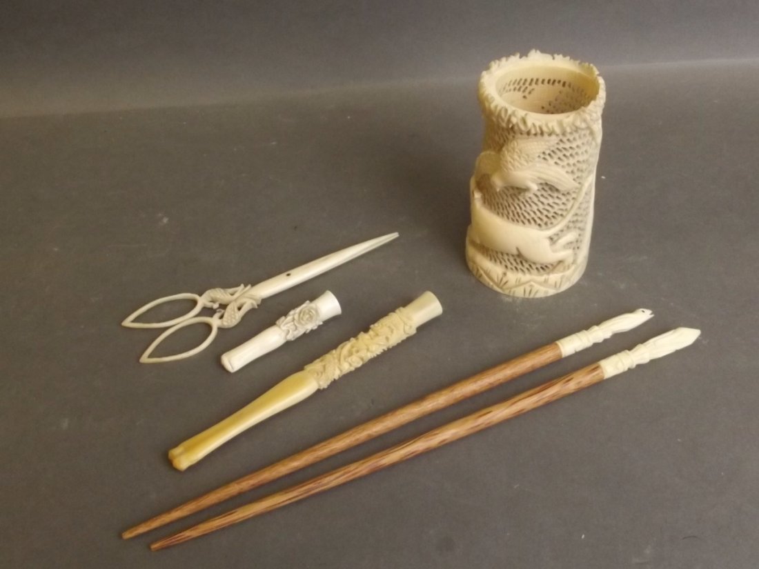 A collection of late C19th carved ivory and bone to: A collection of late C19th carved ivory and bone to include two hairpins with frog decoration, two cheroot holders with foliate and dragon decoration, pair of small glove stretchers, and a pierced orn