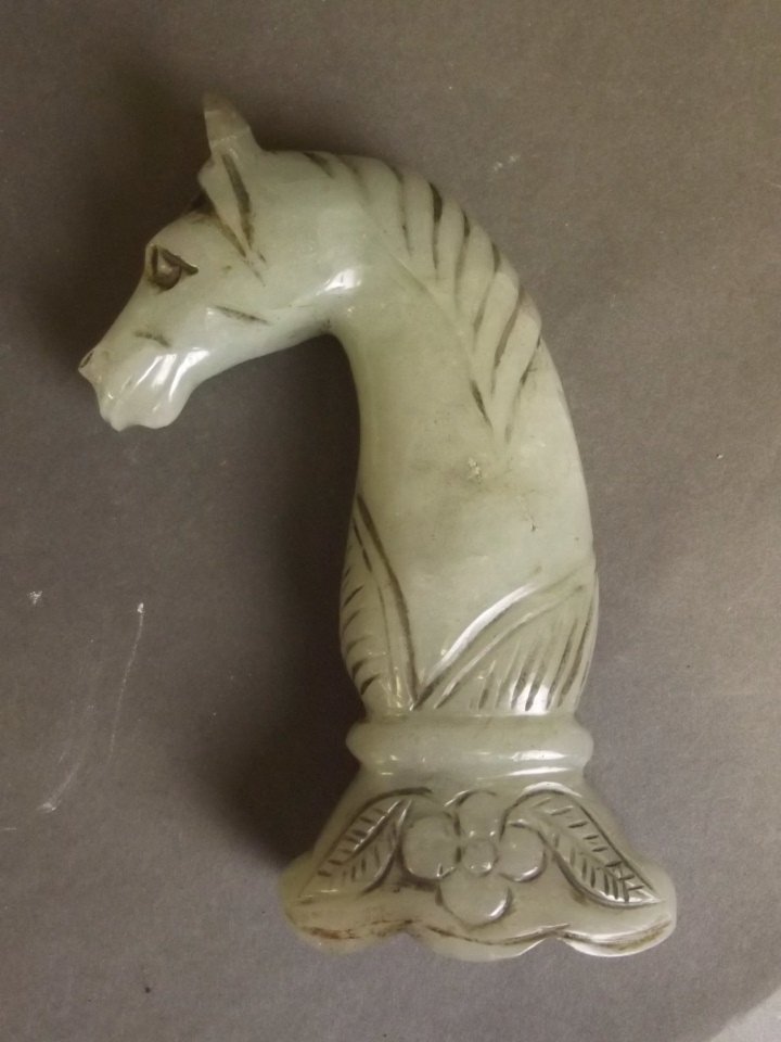 An Islamic celadon jade knife hilt carved in the form (1 of 2)