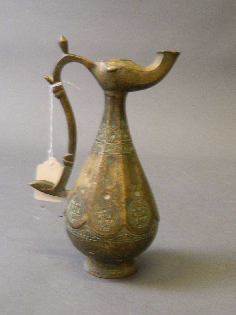 A Middle Eastern bronze ewer with engraved decoration, (1 of 2)