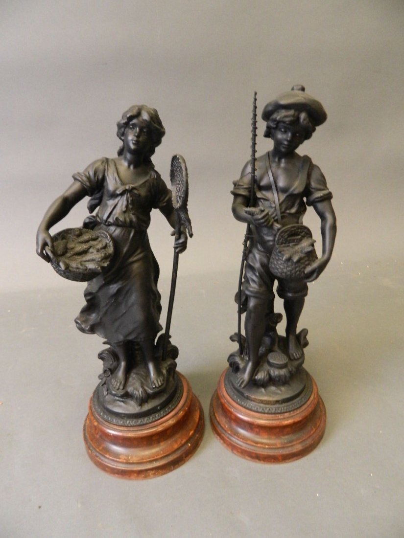 A pair of spelter figures depicting a boy fishing and a (1 of 4)