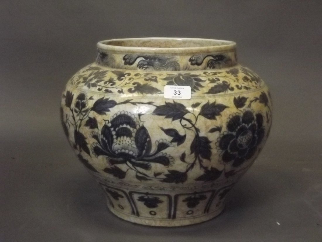 A Chinese blue and white pottery jardiniŠre with: A Chinese blue and white pottery jardiniŠre with trailing flower decoration, 11'' high