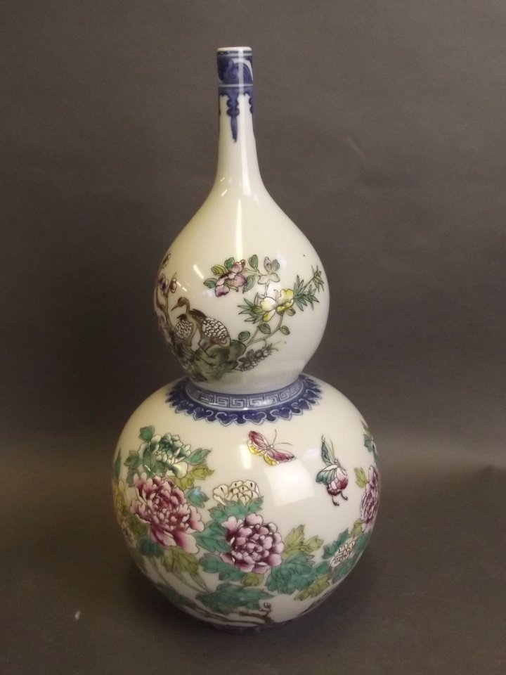 A Chinese double gourd porcelain vase with painted: A Chinese double gourd porcelain vase with painted enamel decoration of birds and butterflies amongst flowers, character inscription verso, stamp mark to base, 12'' high