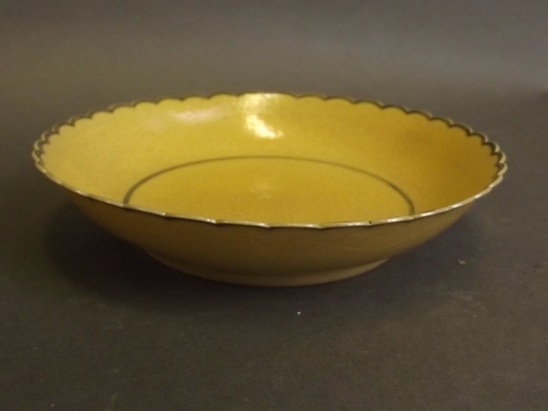 A Chinese yellow ground shallow dish with a shaped rim (1 of 4)