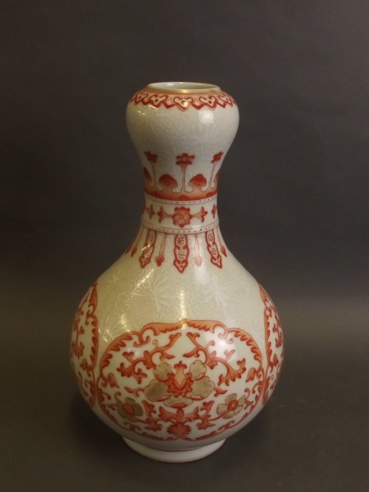 A Chinese porcelain vase with red enamel lotus flower (1 of 3)