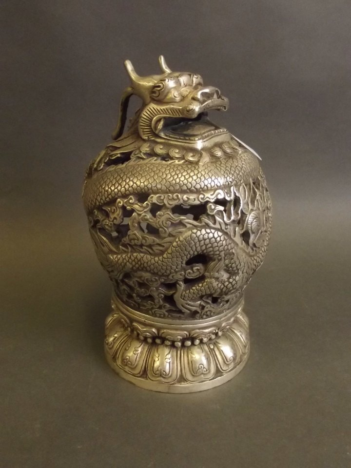 A Chinese pierced and carved white metal censer with: A Chinese pierced and carved white metal censer with dragon decoration, 6«'' high