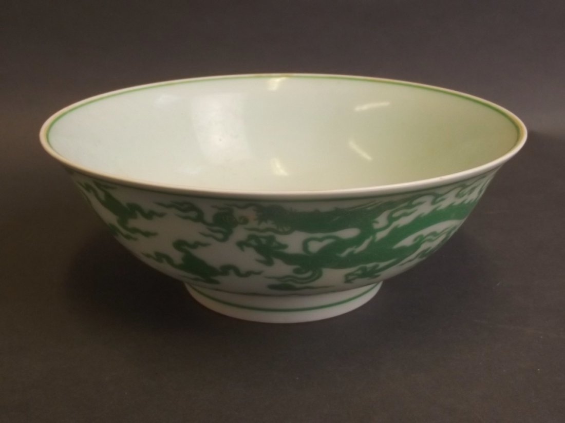 A fine Chinese porcelain bowl with green enamel relief: A fine Chinese porcelain bowl with green enamel relief decoration of a dragon chasing the flaming pearl, 6 character mark to base, 7«'' diameter