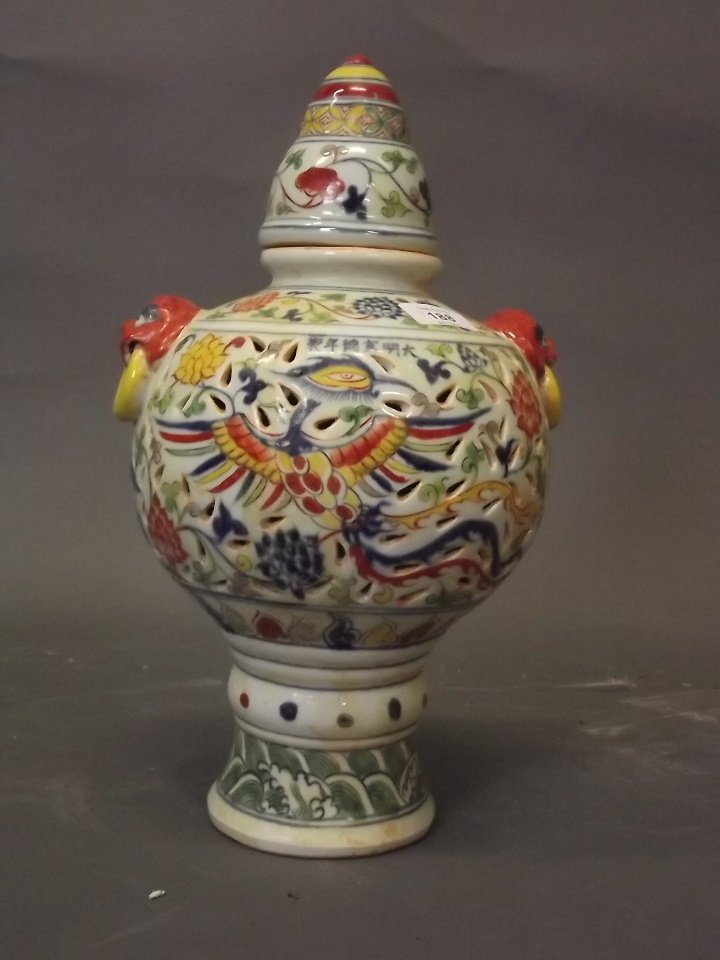 A Chinese jar and cover with pierced body and twin mask (1 of 3)