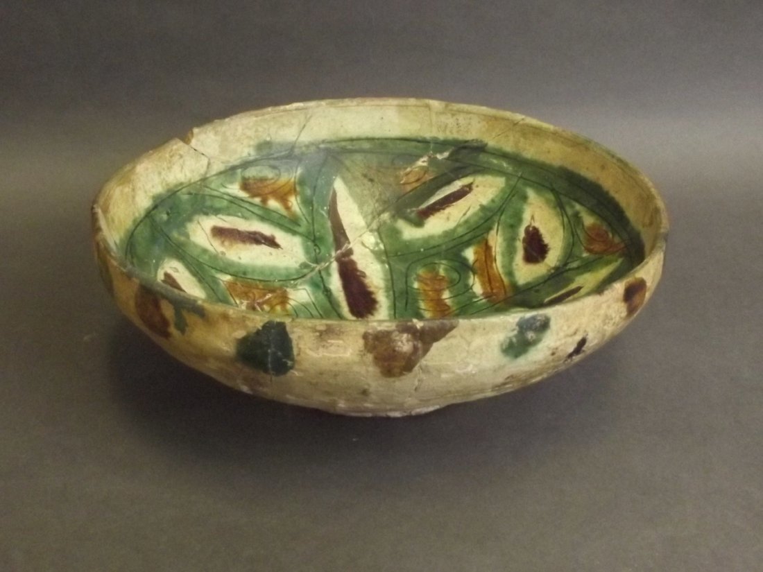A C10th Persian Tang style splashware pottery bowl with: A C10th Persian Tang style splashware pottery bowl with incised decoration, 7«'' diameter (AF restuck)