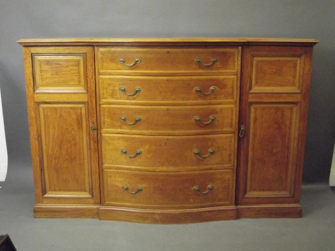 A fine late C19th satinwood serpentine shaped dwarf: A fine late C19th satinwood serpentine shaped dwarf press cupboard with 5 graduated central drawers, inlaid and cross banded decoration, stamped Howard & Sons Ltd., 74«'' x 25'', 48«'' high