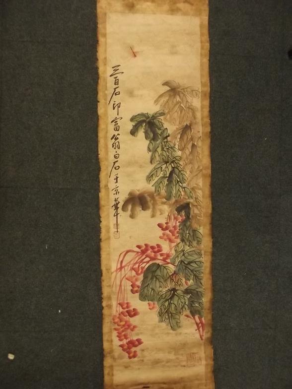 A Chinese hand painted scroll decorated with a: A Chinese hand painted scroll decorated with a dragonfly and foliage, with calligraphy and seal mark, 52" x 13"