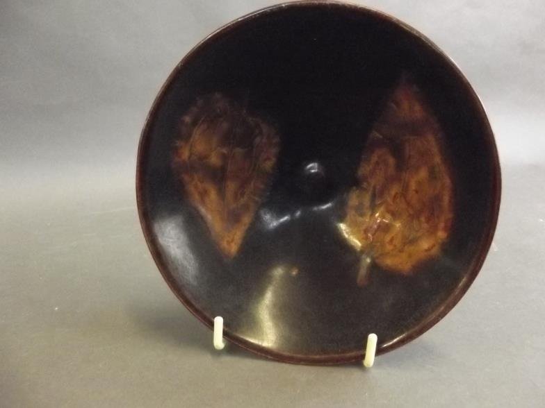 A Chinese stoneware kiln ware bowl decorated with: A Chinese stoneware kiln ware bowl decorated with leaves, 6" diameter