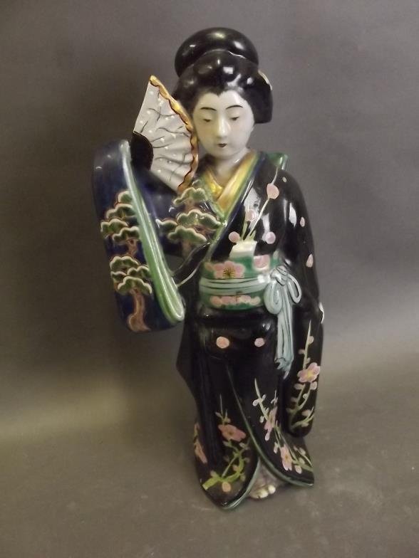 A Japanese porcelain figure of a Geisha, 11Â½'' high: A Japanese porcelain figure of a Geisha, 11Â½'' high (AF repair to fan)