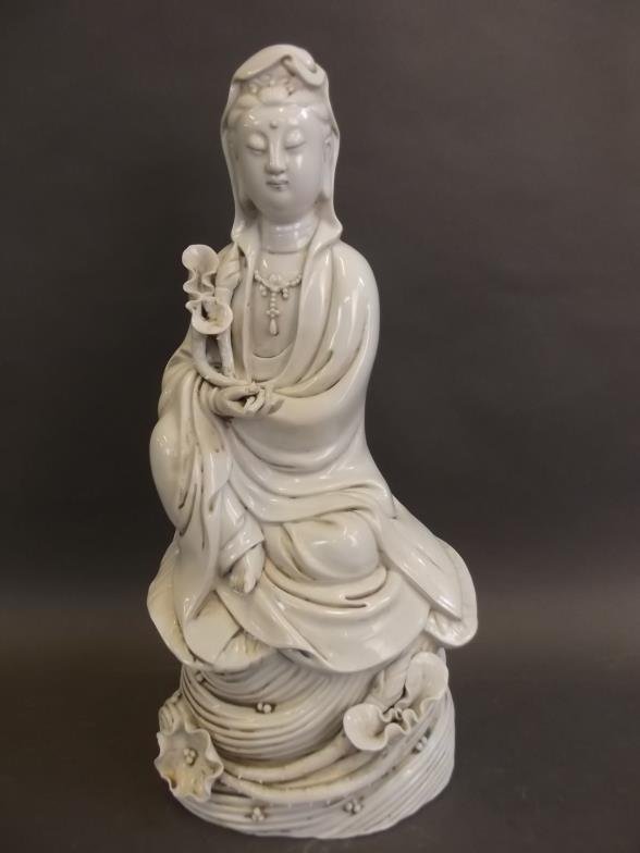 A Chinese blanc de chine porcelain figure of Quan Yin, (1 of 3)