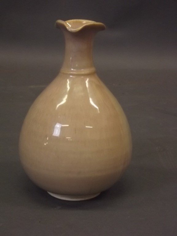 A Studio pottery vase of baluster form and shaped rim: A Studio pottery vase of baluster form and shaped rim with a buff coloured drip glaze, 6Â½" high