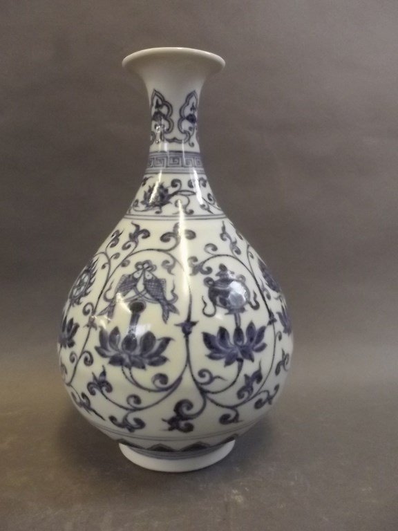 A Chinese blue and white porcelain vase with bulbous: A Chinese blue and white porcelain vase with bulbous body and slender neck, decorated with stylised lotus and symbols, seal mark to base, 10" high