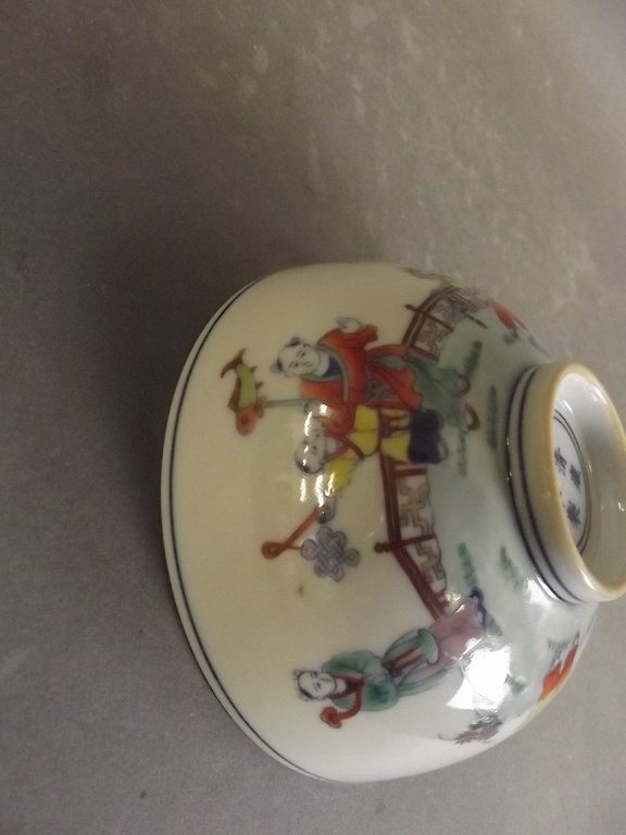 A Chinese Doucai porcelain bowl decorated with children: A Chinese Doucai porcelain bowl decorated with children playing in a garden, 6 character mark to base, 4Â½" diameter