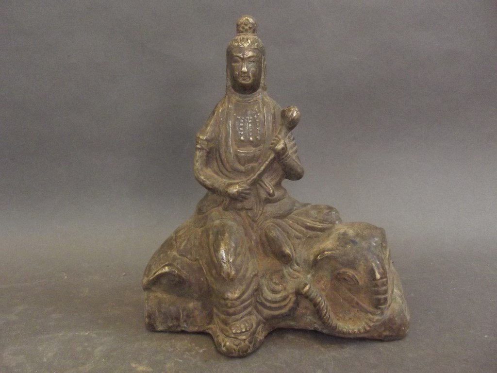 A Chinese bronze figure of Quan Yin seated on an: A Chinese bronze figure of Quan Yin seated on an elephant, 7" high